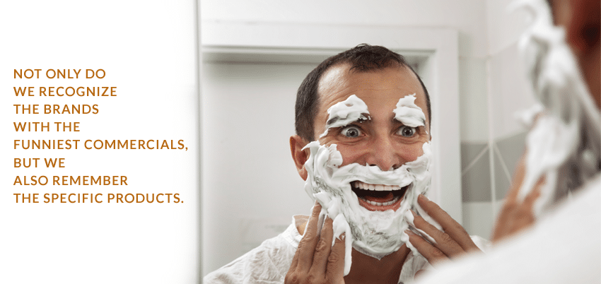 Person with shaving cream on their face and eyebrows, looking into a mirror smiling with orange marketing font for commercials.