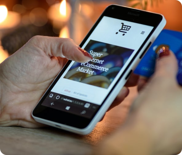 Person scrolls through a website on their mobile phone, shopping an eCommerce site.