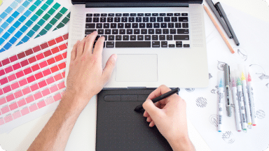 Drawing pad, stylus, and color chars are on a desk for custom designs