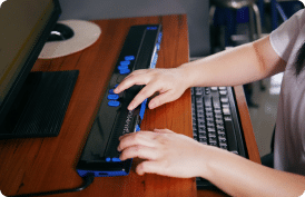 person using a braille keyboard
