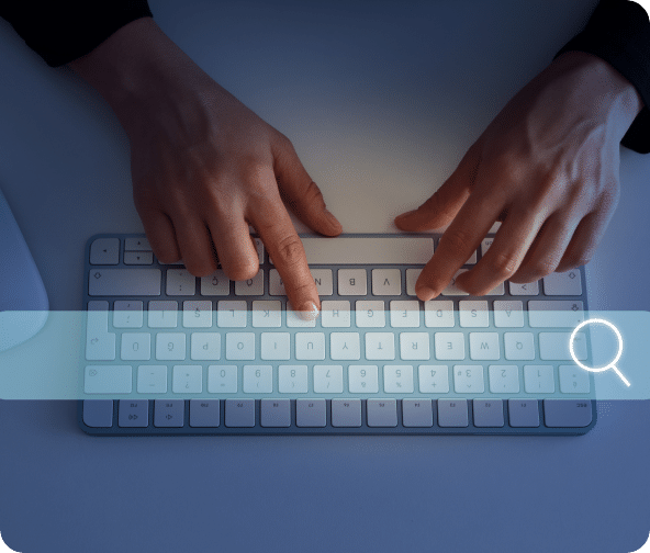 Search bar across the screen with a keyboard and users hands.
