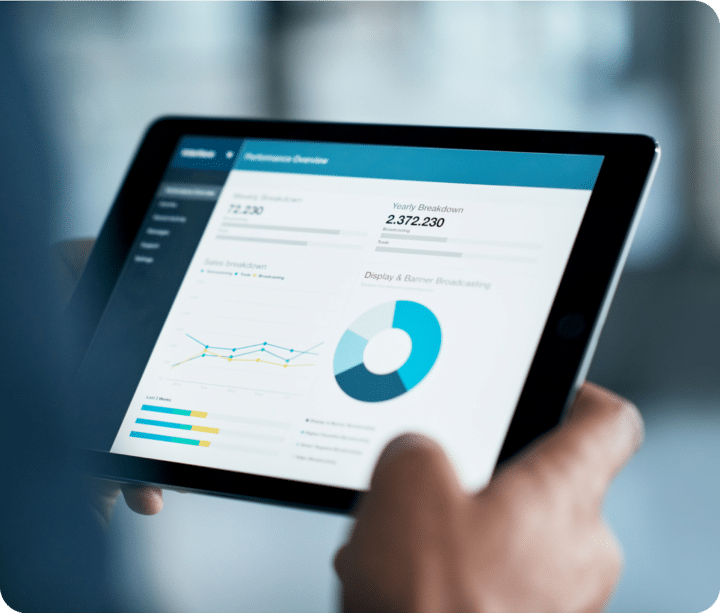 Person holds a tablet looking at the yearly ROI breakdown.