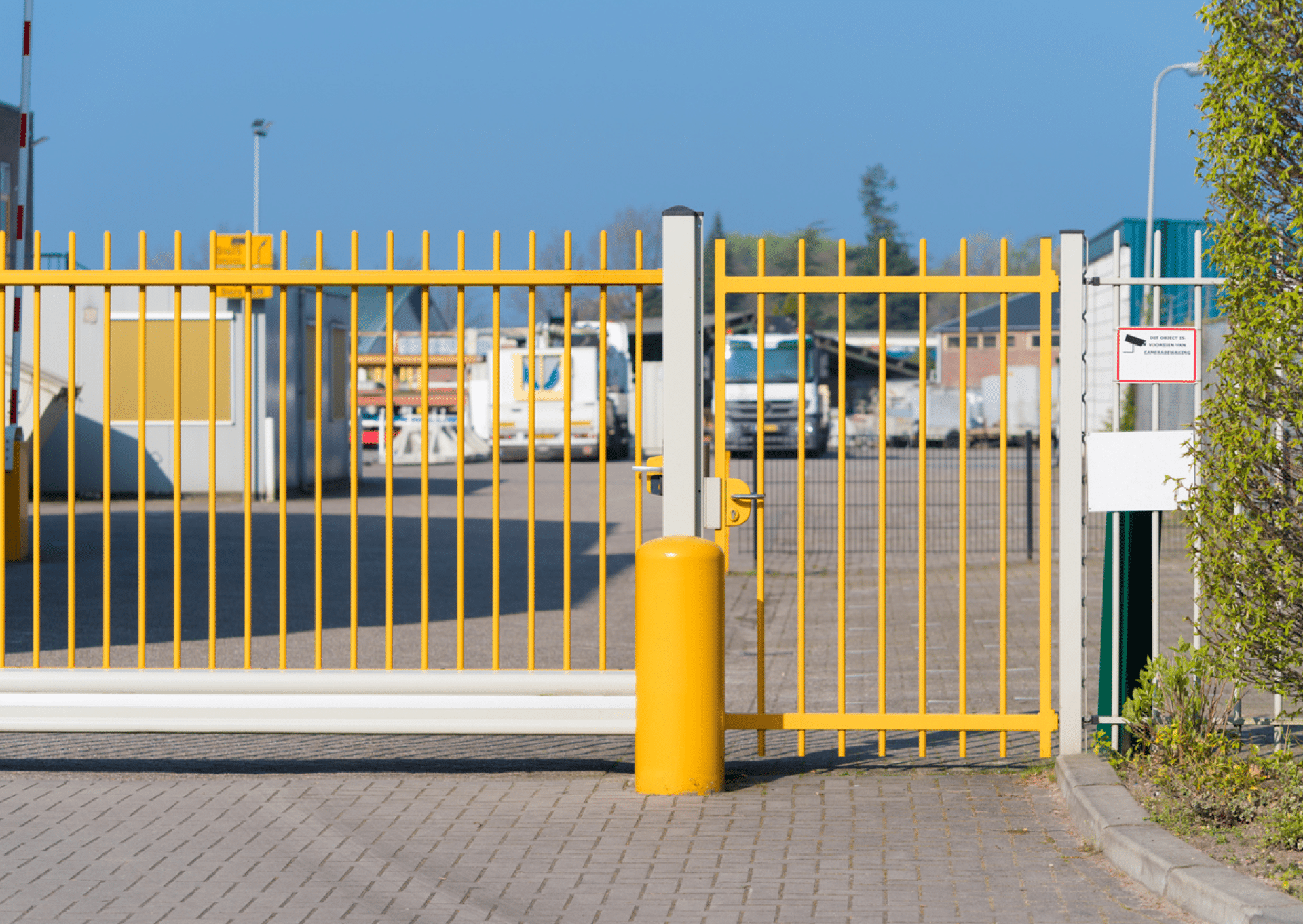 Automatic gate with side entry keypad access gate installed and serviced by Guardian Access Solutions.