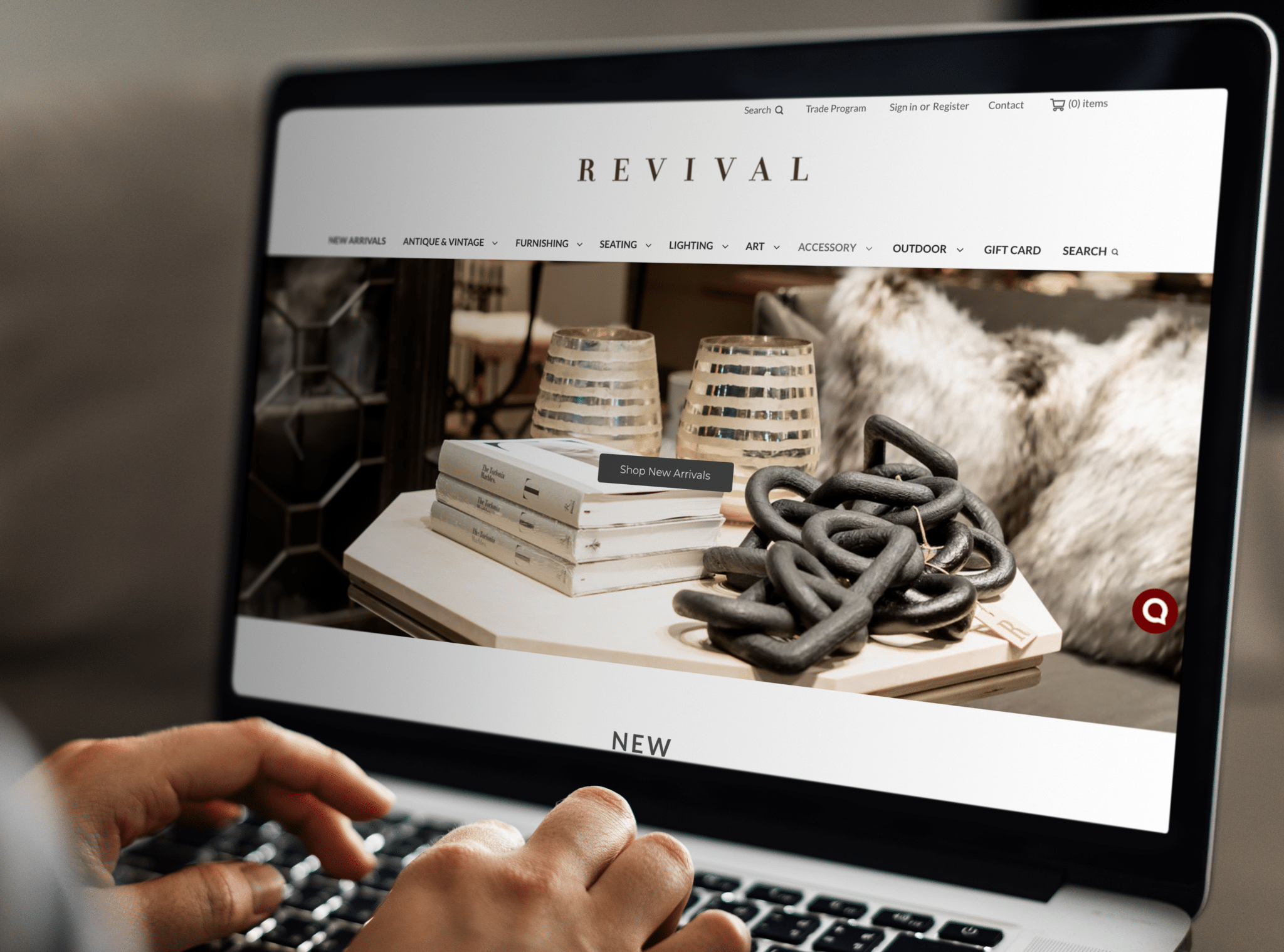 Hands on a laptop keyboard as they shop the Revival website.