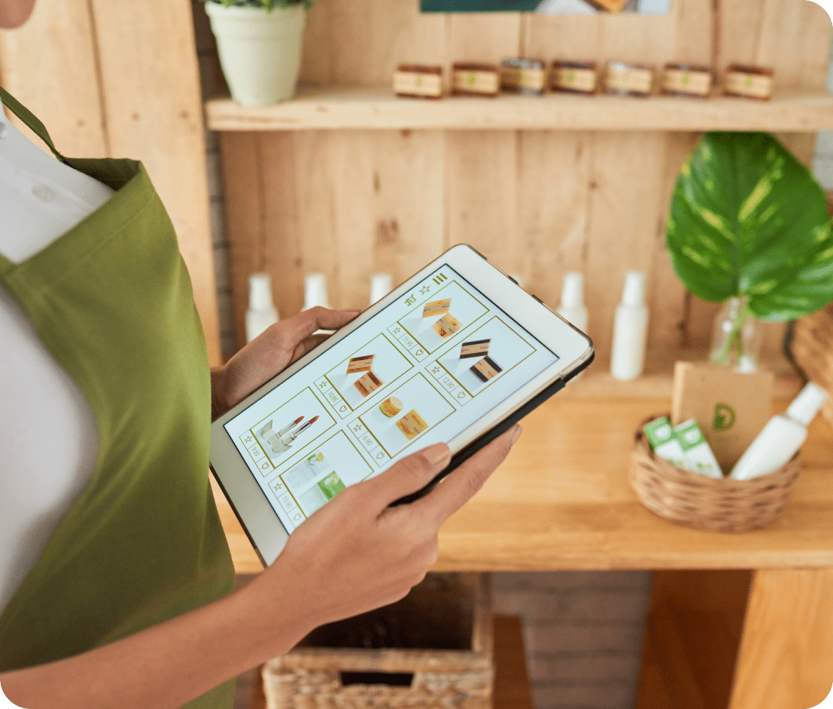Person holds a tablet with their website displayed showing products they're selling.