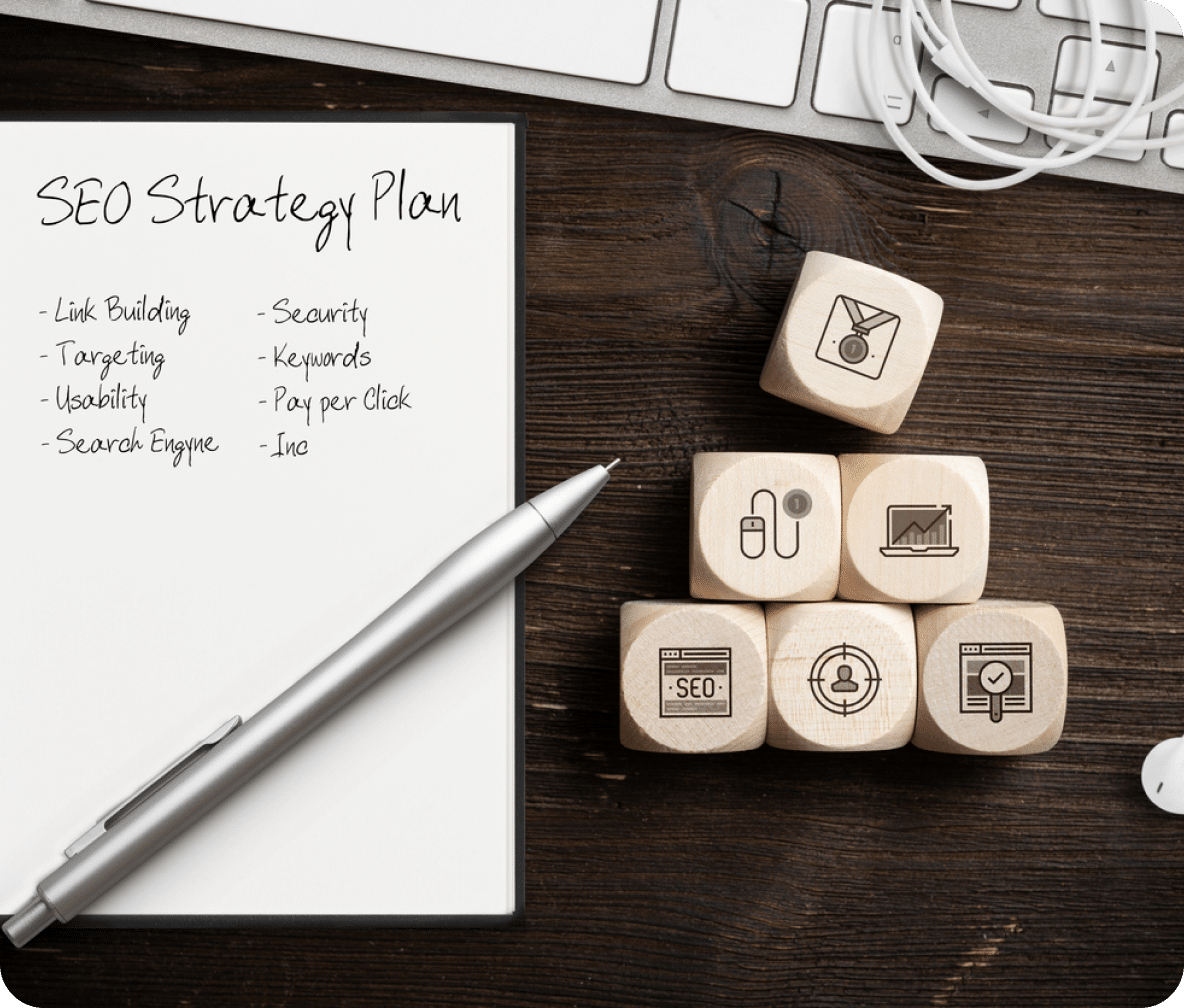 Dice are stacked to the side in a pyramid with a notepad and pen to the side for SEO Strategy Plan.