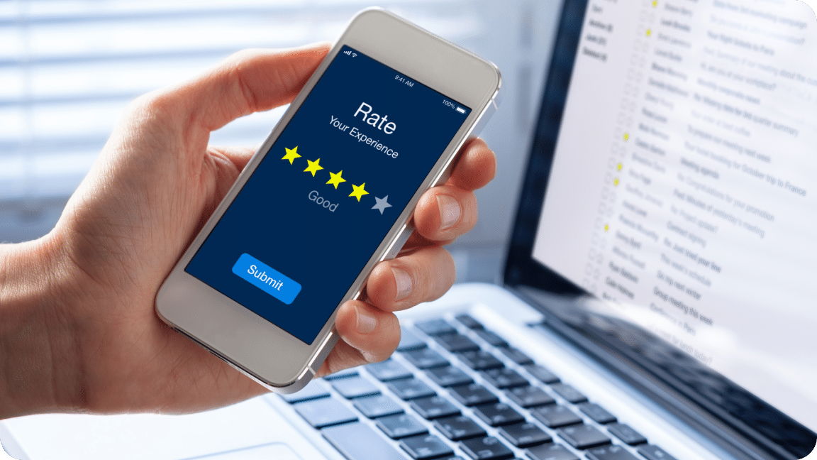 Person holds their cellphone with the screen showing a review survey with 4 of 5 stars selected.