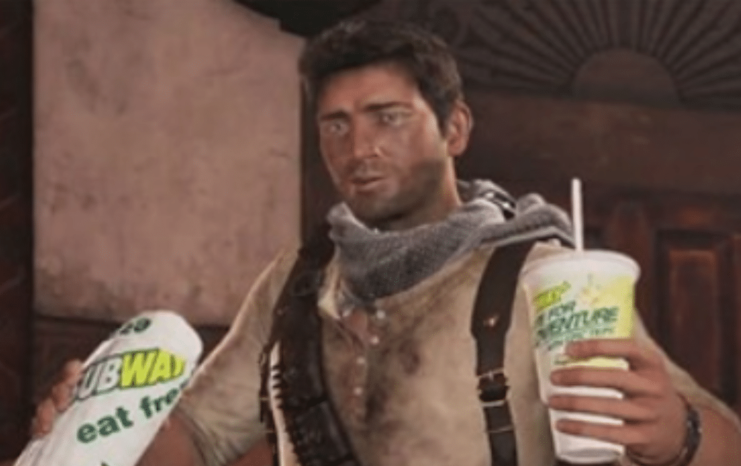 Video game character holding a Subway sandwich in the logo wrapper with a Subway cup in the other.